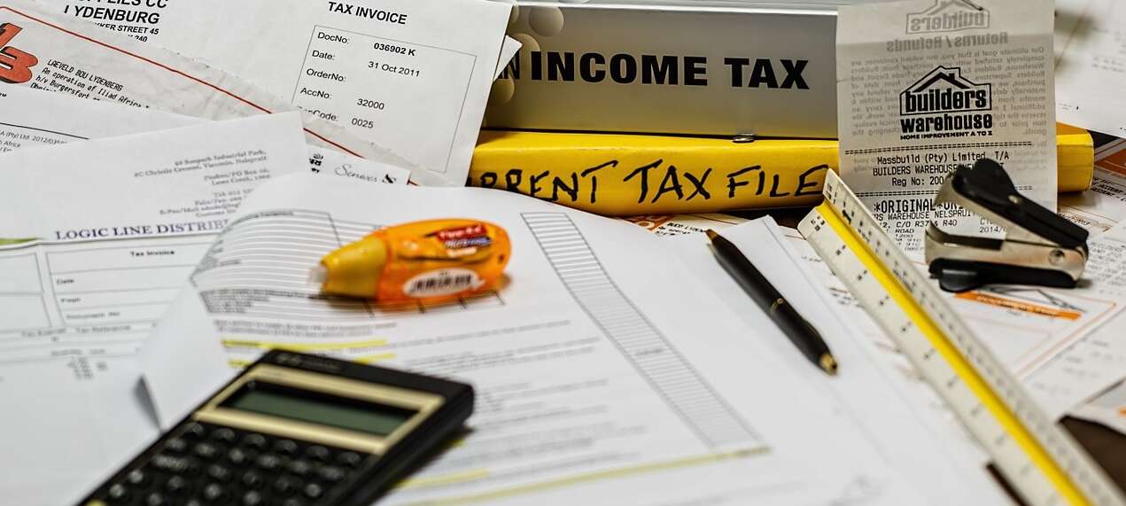 a photo of a mess of tax receipts and a calculator