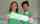 A woman and a man wearing matching gree nshirts hold a sign that reads MealCare