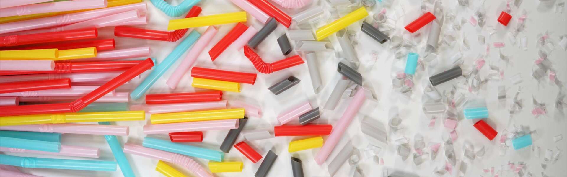 Drinking straws cut into smaller and smaller pieces are spread on a table