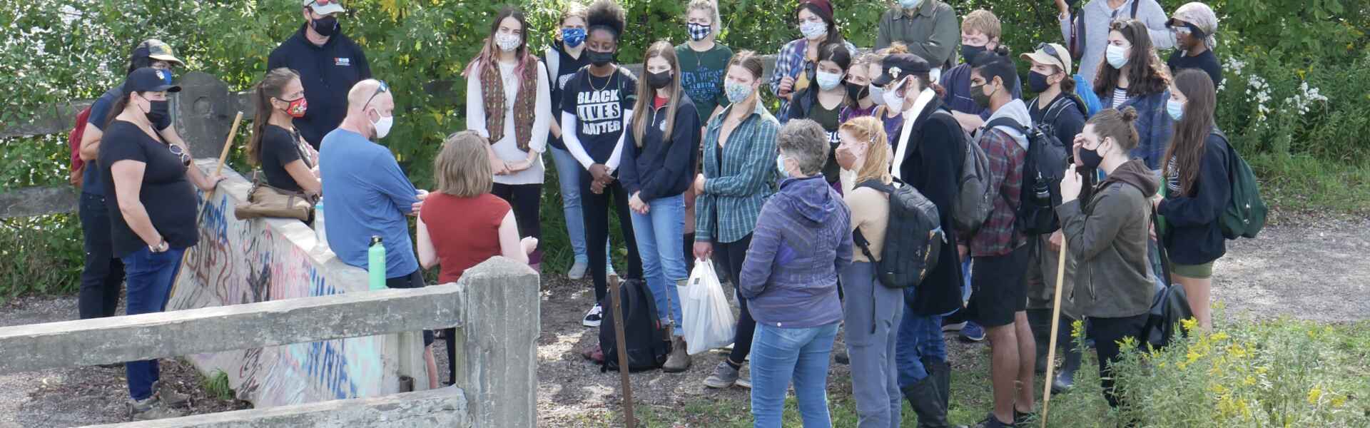 About 20 students in a group outdoors