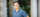 A man in blue shirt stands before the U of G portico