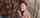 Emma Hak-Kovacs stands amid snow and smiles looking off-camera