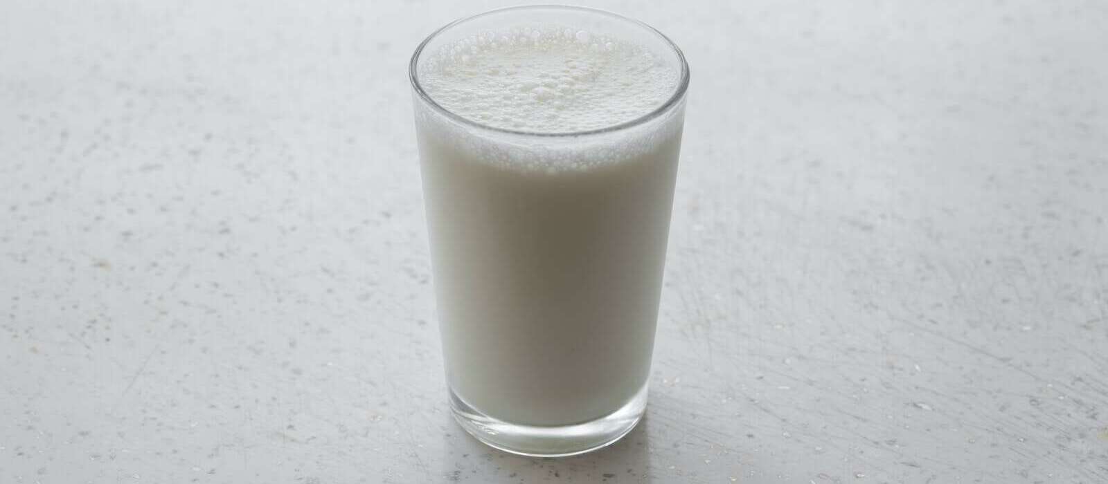 clear drinking glass with brown liquid