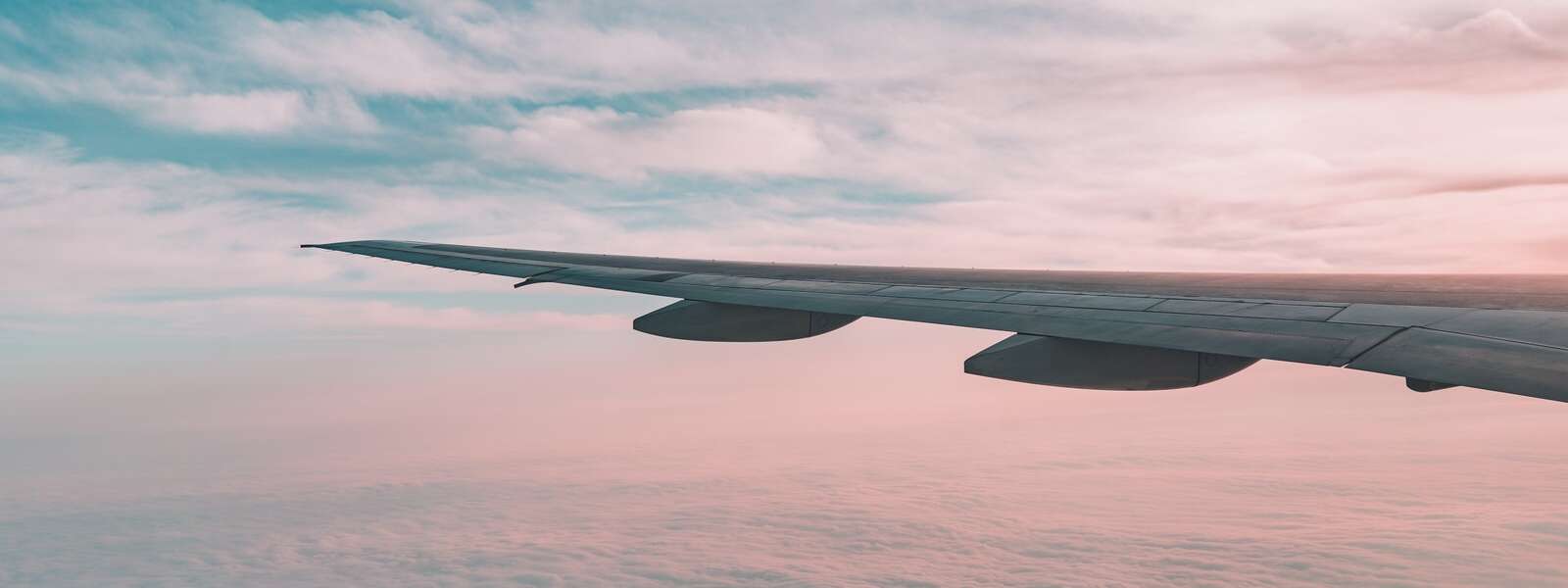 An airplane wing at sunset