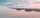 An airplane wing at sunset