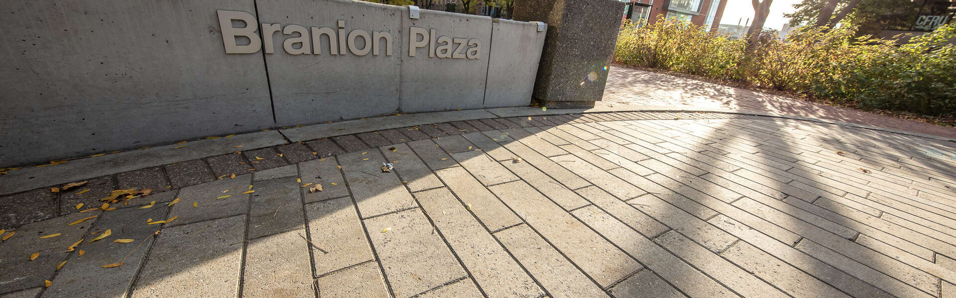 a low concrete wall with the words Branion Plaza