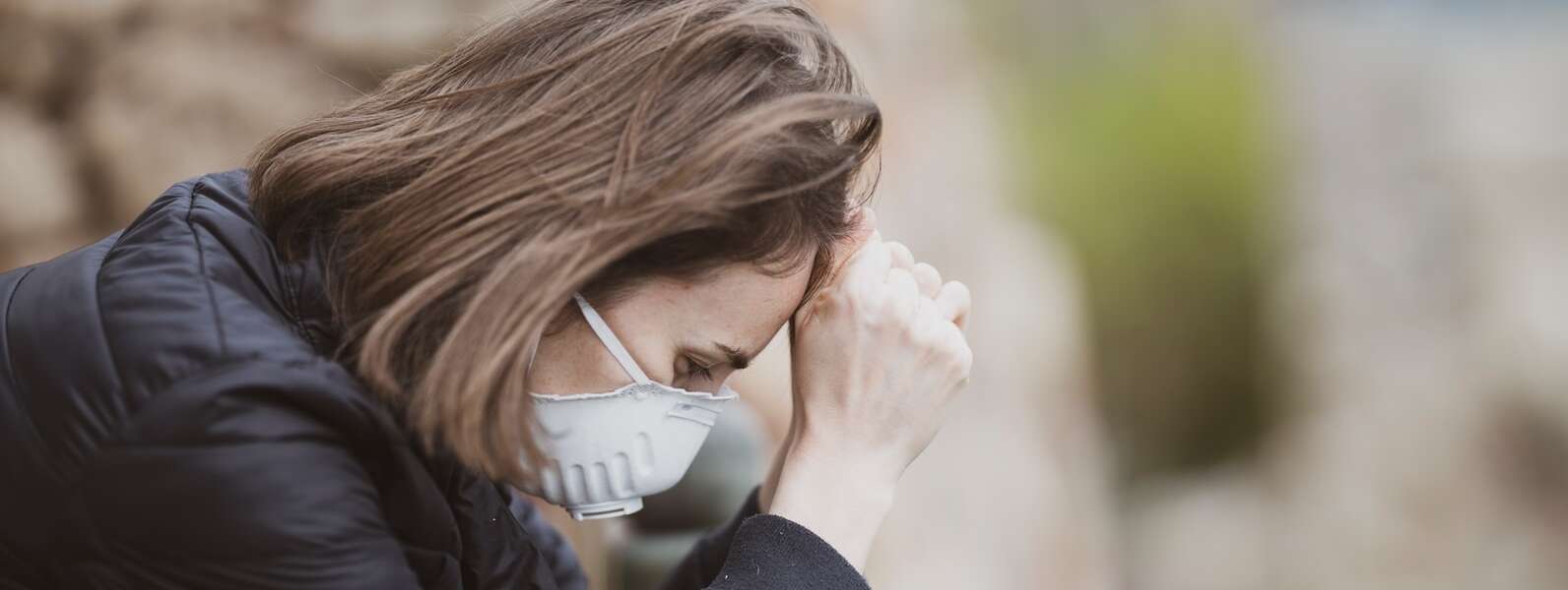 woman in black leather jacket wearing white framed eyeglasses covering her face