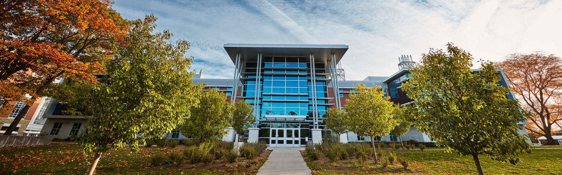 wide view of Alexander Hall and trees in early fall.