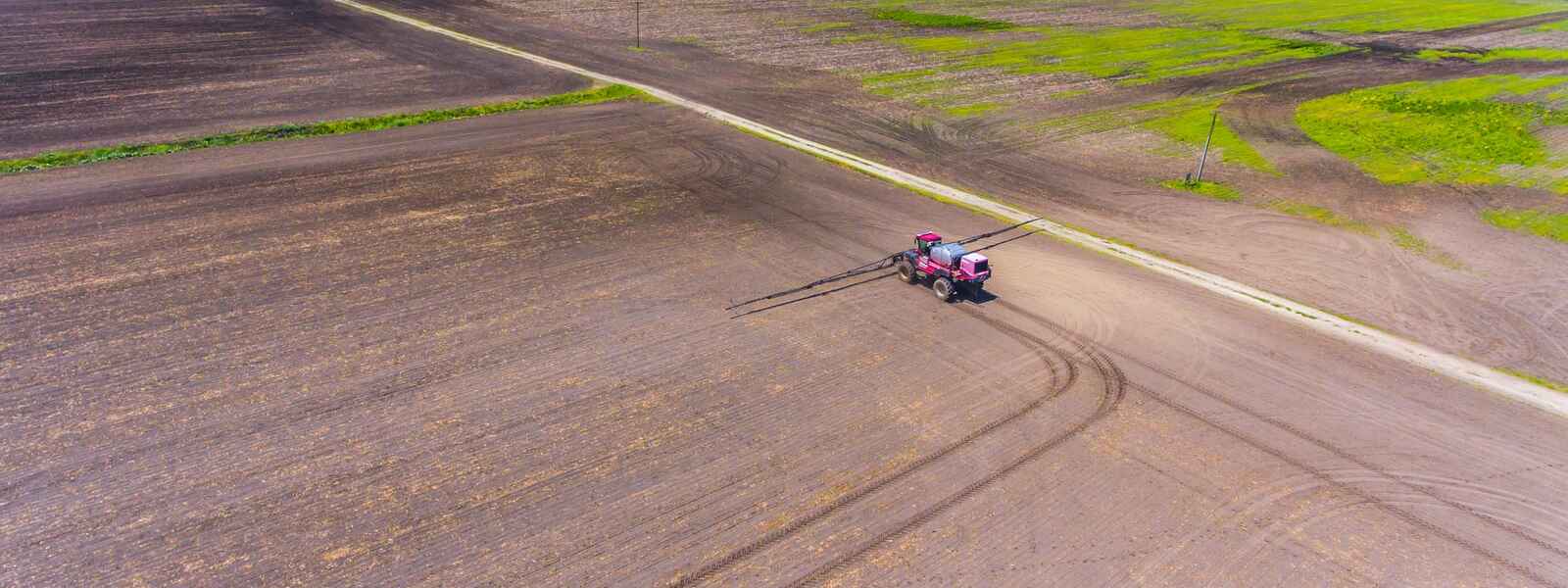 A sprayer applies fertilizer to a field.