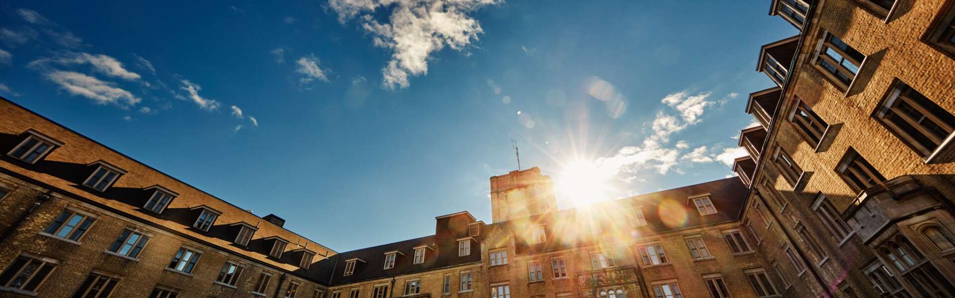 A setting sun over a building on the U of G campus