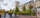 A wide view of students walking past ivy-covered Johnston Hall