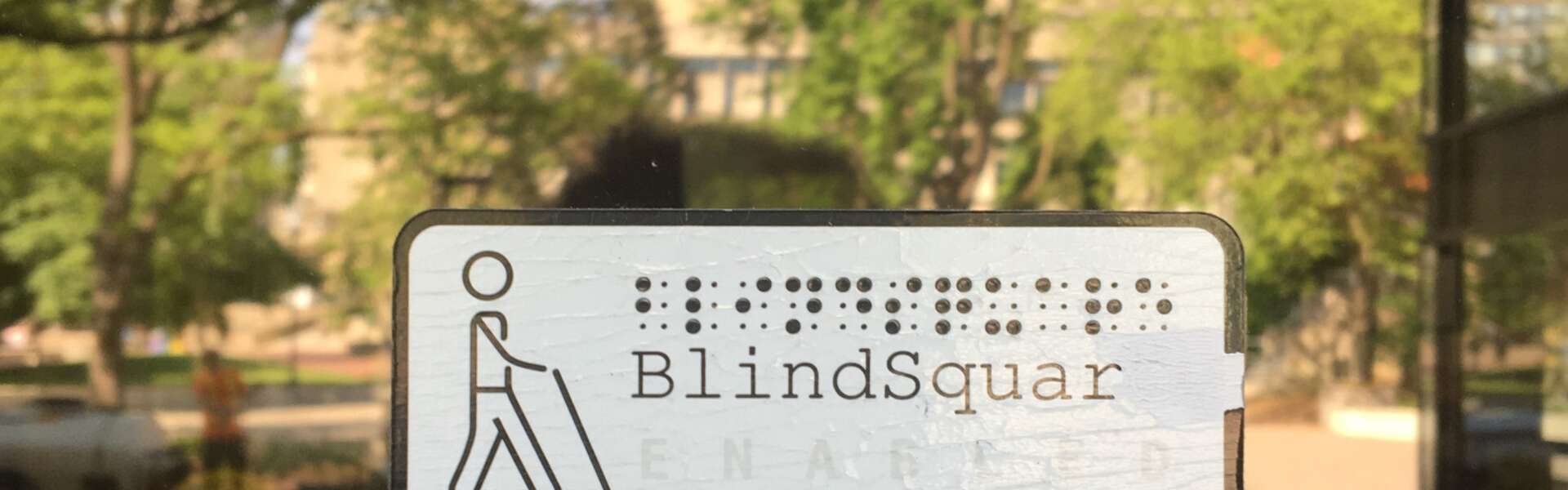 A BlindSquare sign appears on a glass door of the University Centre