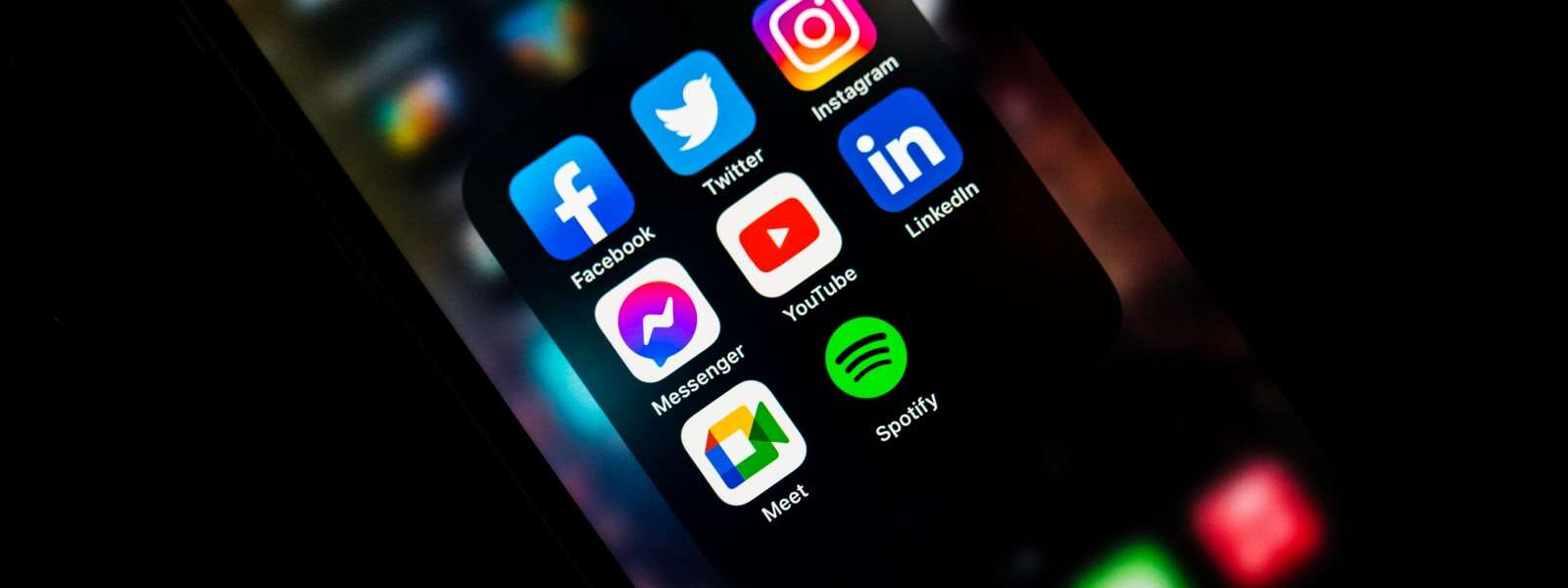 Social media icons on a phone screen.