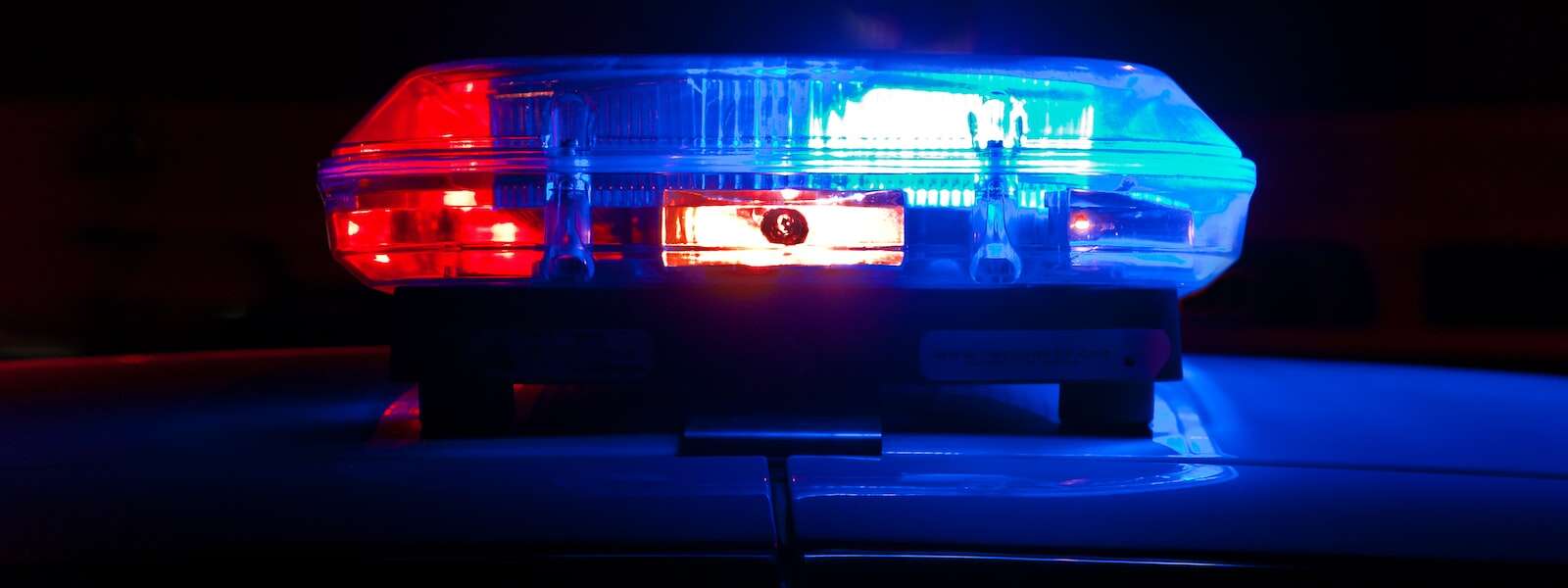 An image of red and blue police lights against a black background.