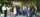Seventeen people stand in two rows in a gazebo