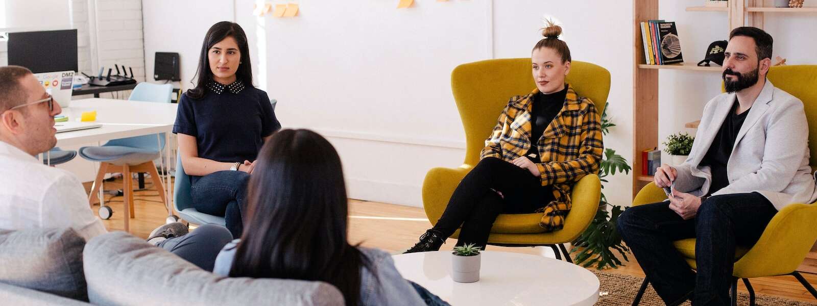 People seated around a table in a meeting room.