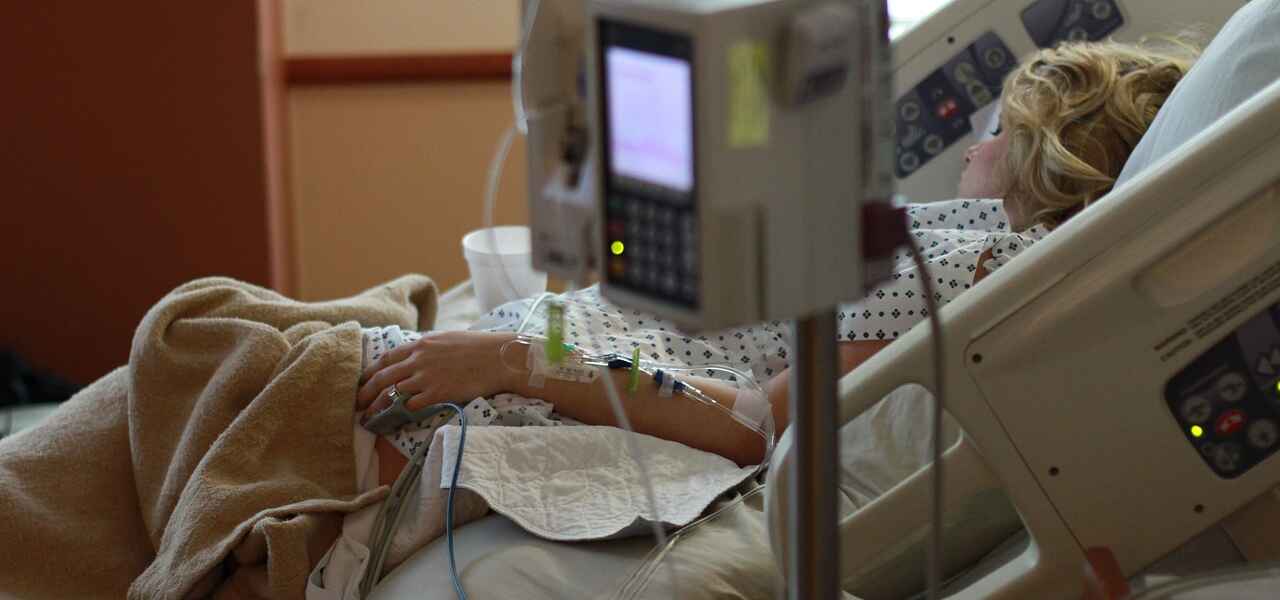 A person sleeps in a hospital bed