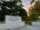 The University of Guelph sign is pictured among trees.