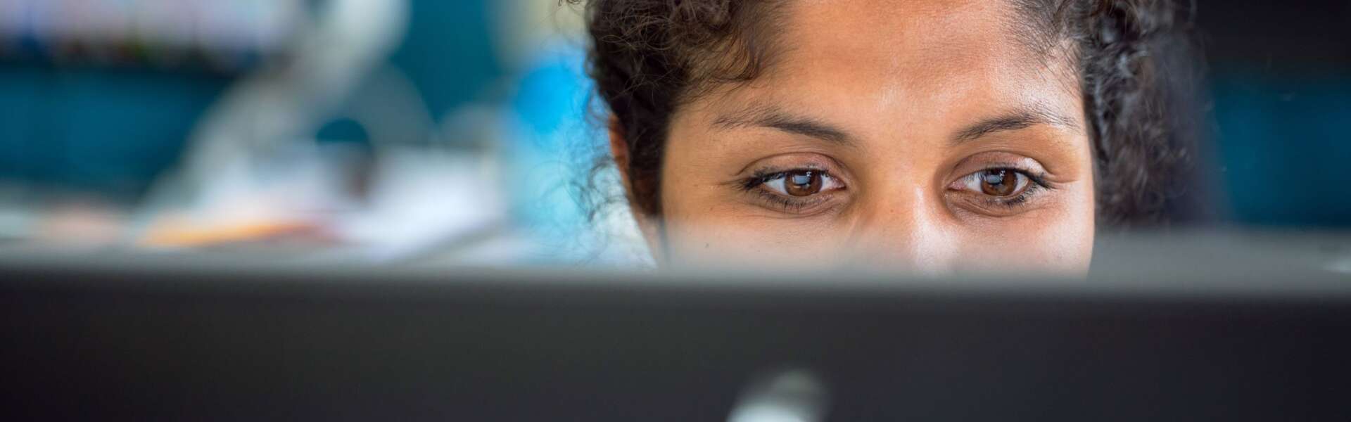 A woman watches their computer screen