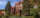 A red brick building with a green lawn in front of it,