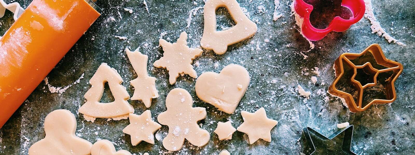 Macro photography of different cookies, cookie cutters and rolling pins