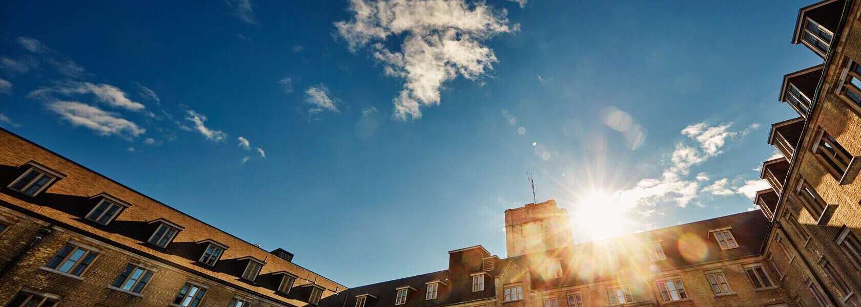 A setting sun over a building on the U of G campus