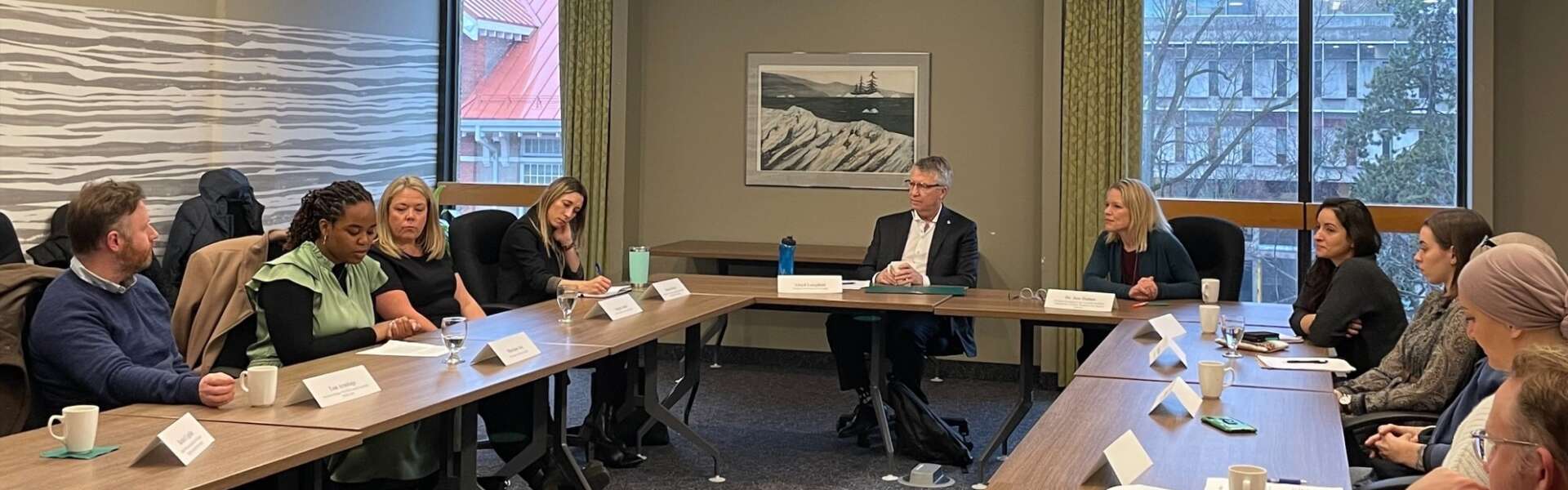 MP Lloyd Longfield, with Dr. Jess Haines to his left and Jessica Bowes, AVP, research (innovation & knowledge mobilization) on his right, with community advisers sit a U-shaped boardroom table