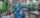 people in blue coveralls and masks work in a factory