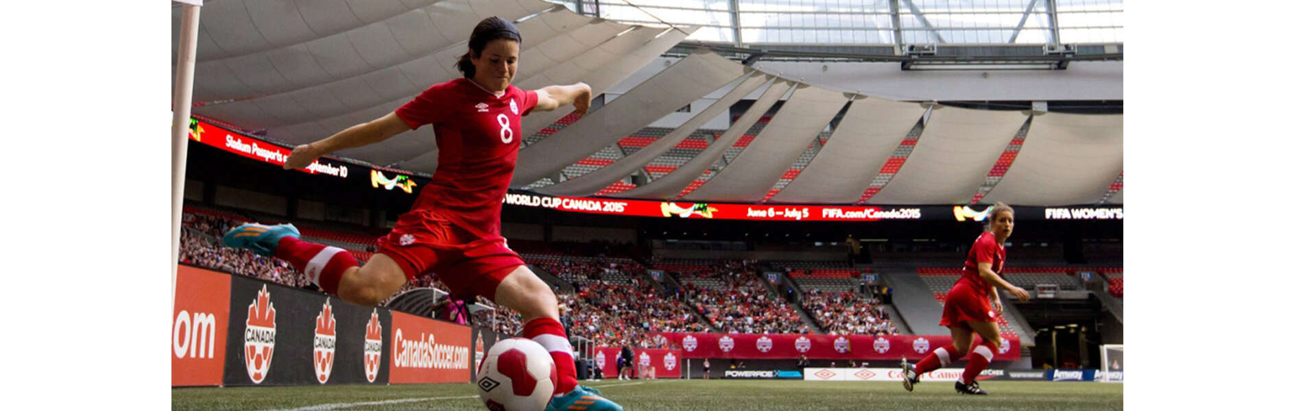 A photos oDiana Matheson setting up to kick the ball in a large soccer arena