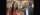Two people hold up bioplastic cutlery and smile for the camera
