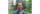 Lawrence Hill smiles for a portrait while standing outside with trees behind