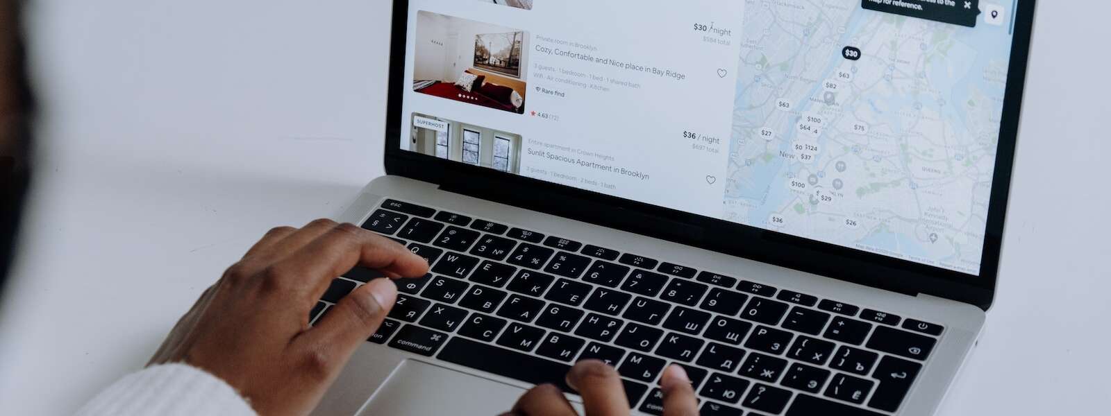 Person Using Macbook Pro on White Table