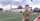 a reservist soldier wears an operational uniform while standing on a football field with bleachers behind