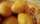 A closeup of a wicker basket full of potatoes