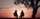 silhouette of two person sitting on chair near tree