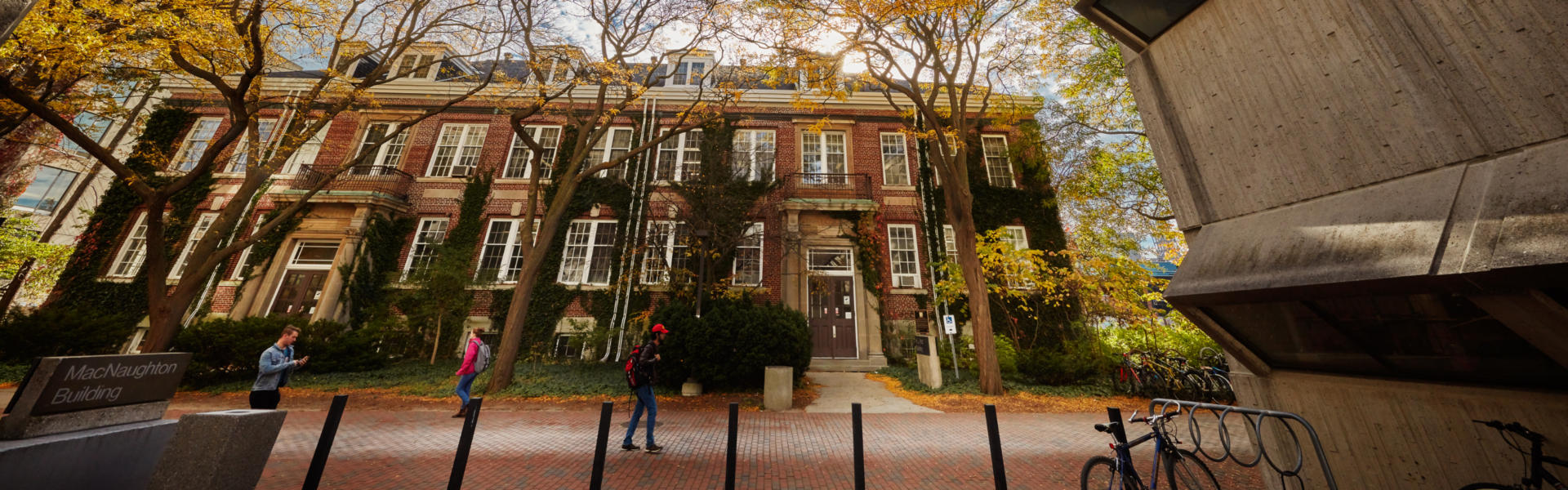 Students walk down the path in front of The H.L. Hutt Building.