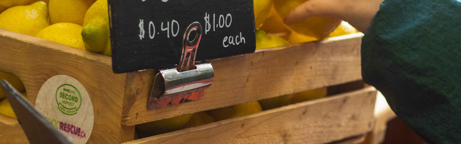 A person reaches for a lemon at the U of G Food Market.