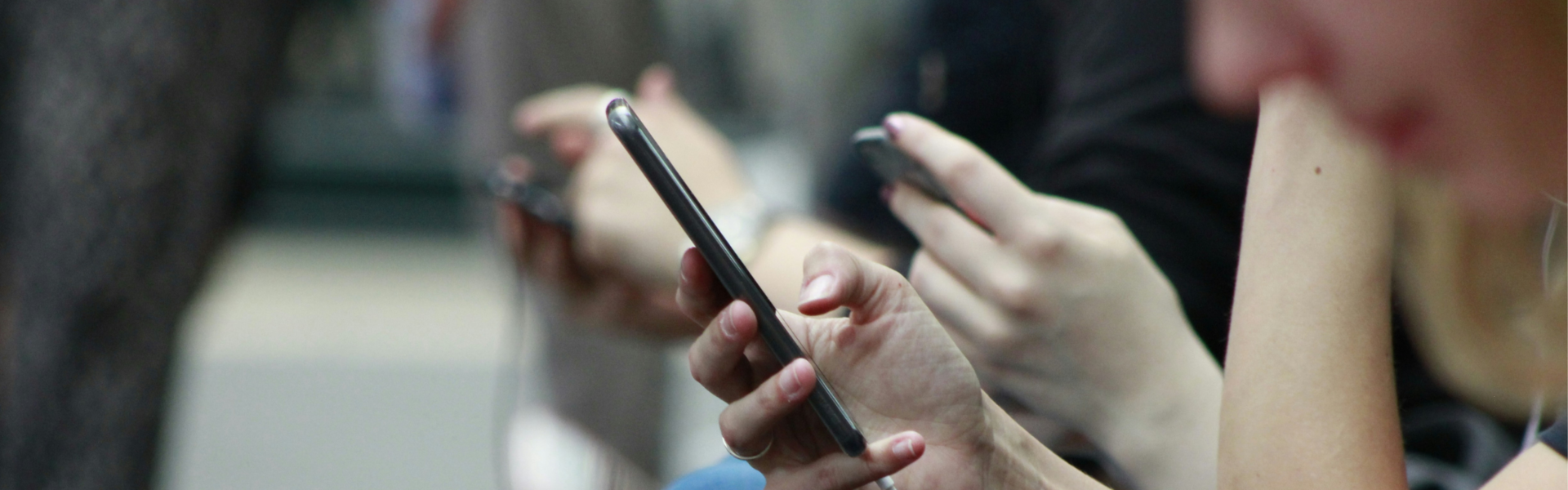 Hands holding smart phone during a commute