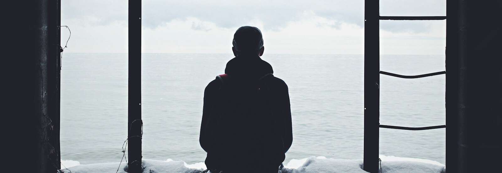 person looking out through window