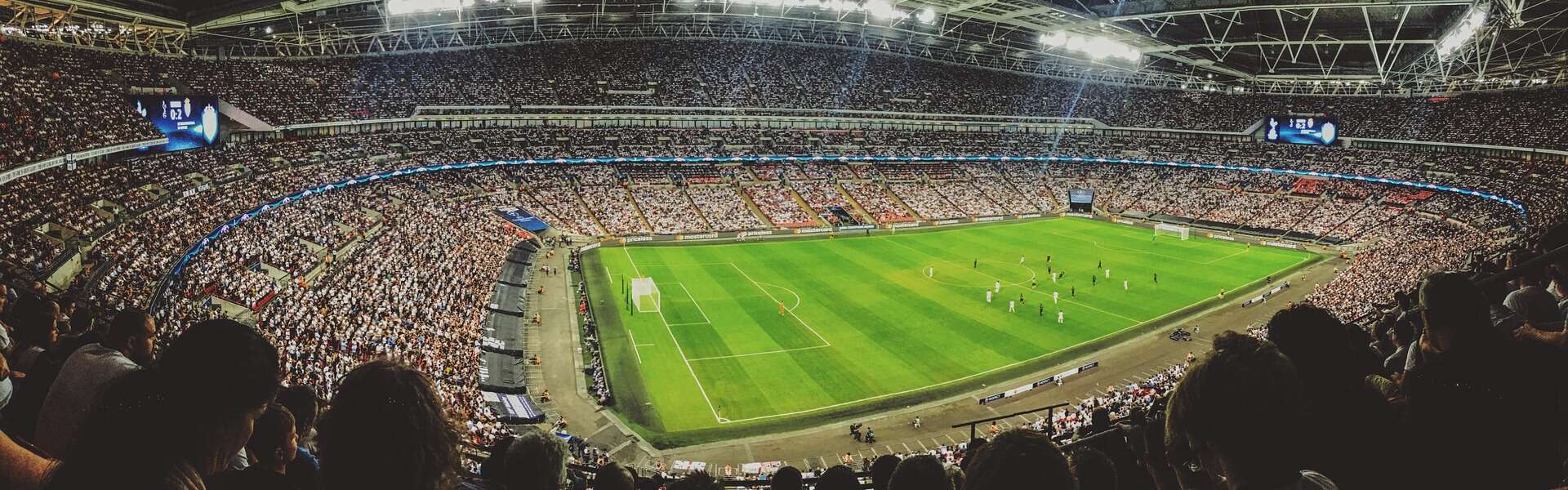 A wide shot of fans at a packed soccer stadium