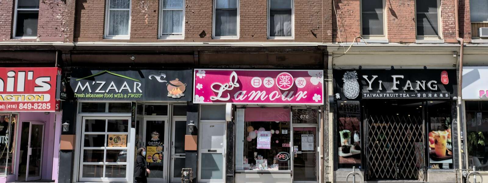 a Toronto street with many storefronts and restaurants
