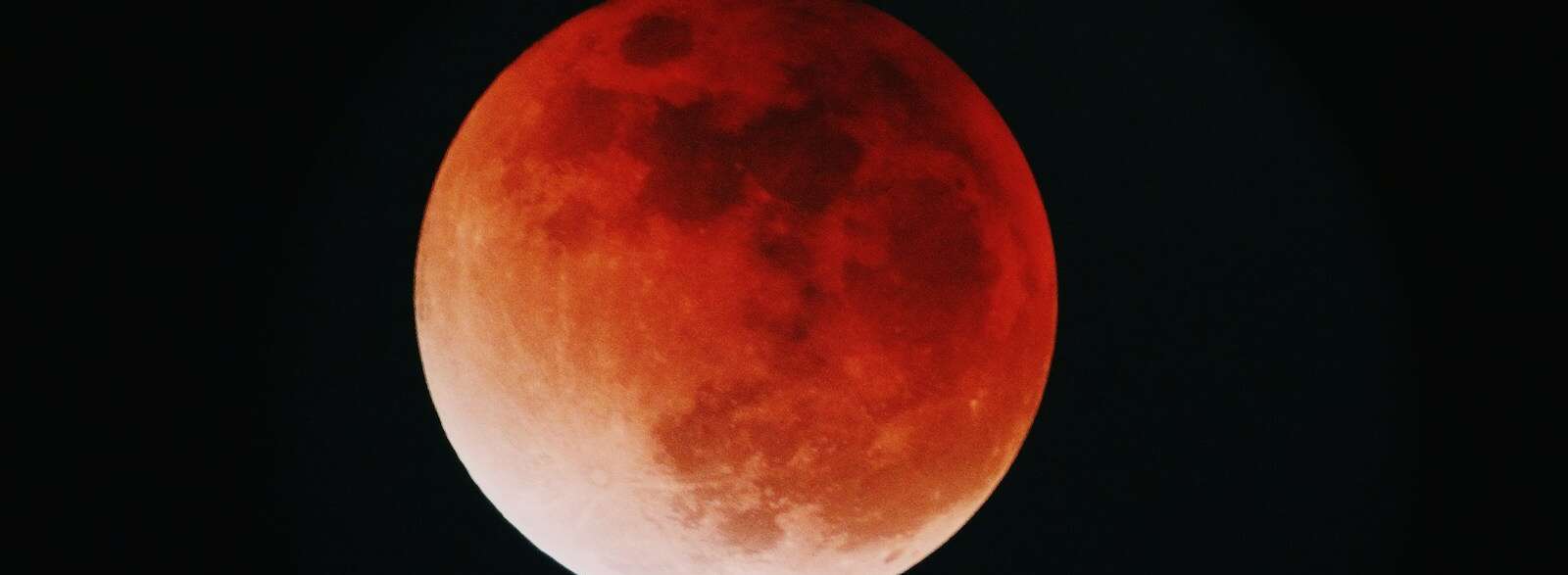 red moon in a black night sky