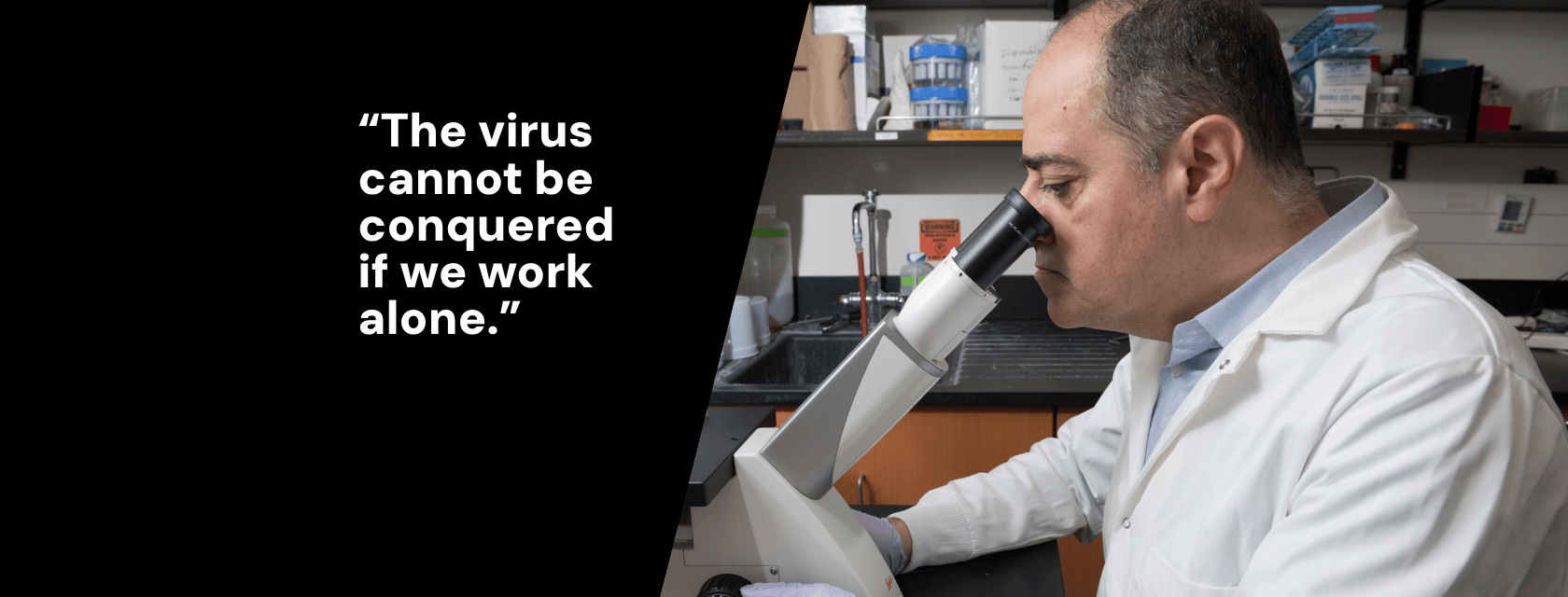 A researcher in a lab coat looks through a microscope. Bold text that reads, "The virus cannot be conquered if we work alone."
