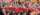 students dressed in red shirts pose in a crowd in the bleachers