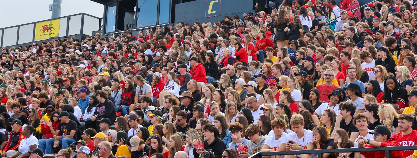 fans dressed in red and white watch a sporting event