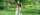 Person with prosthetic leg poses with dog against greenery