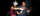 A person wearing a VR headset is directed by a man on how to use the handset