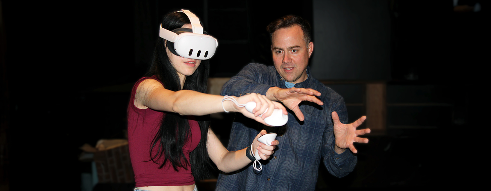 A person wearing a VR headset is directed by a man on how to use the handset