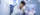 Student researcher in lab coat uses pipette at lab bench