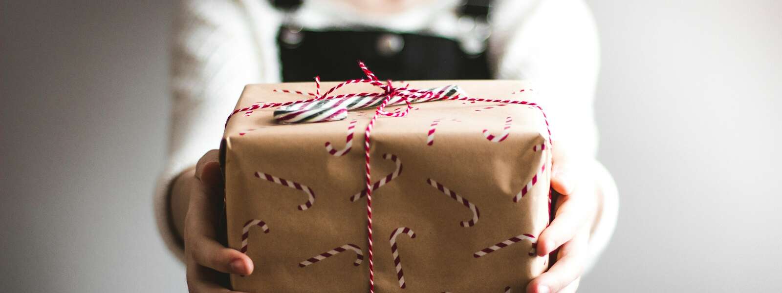 person showing brown gift box